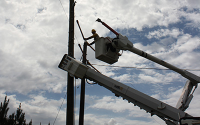 Lineman fixing a line from bucket truck